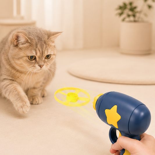 Cat playing with a Interactive Flying Disc Launcher Cat Toy held by a person on a light-colored floor.