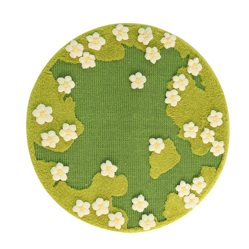 Round green rug with white floral patterns on a white background