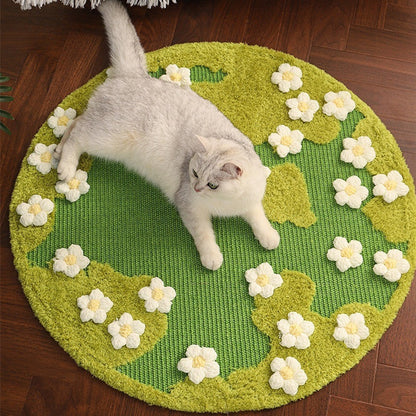 Cat lying on a green round rug with white floral patterns on a wooden floor.