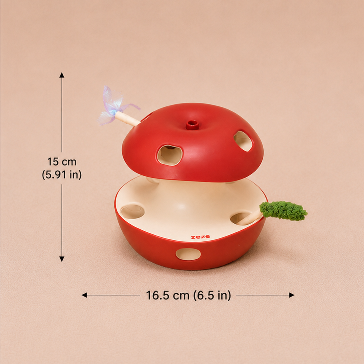 A red apple-shaped cat toy with a cream-colored interior, shown with dimension arrows and text indicating a height of 15 cm (5.9 in) and width of 16.