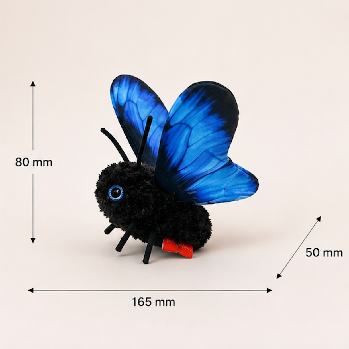 A black fuzzy butterfly plush toy with bright blue wings and a small red tail, shown on a light beige background with dimension arrows and labels indicating 80 mm height, 165 mm width, and 50 mm depth.